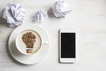 Cup of coffee with lightbulb made of cinnamon. Energy. Morning coffee energy.  Brain storm or idea concept. Coffee-break.