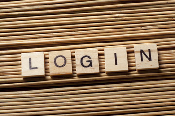 LOGIN word written on wood block at wooden background