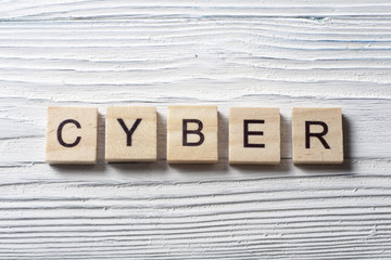 CYBER word written on wooden cubes at wood background