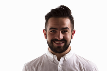 Portrait of happy handsome man smiling for camera isolated on white. Young hipster man with beard posing for fashion or vogue magazine.