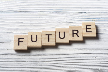 Future word written on wood abc cube with wooden background