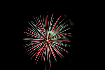 RedWhite and green fireworks light the sky on the 4th of July