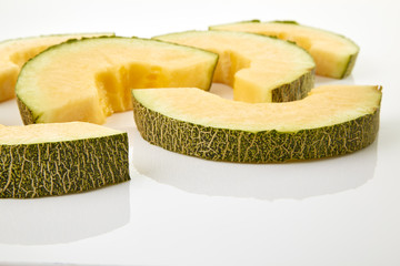 Hamigua Melon cut into slices, Hami Melon, Hami Cantaloupe isolated on white background.