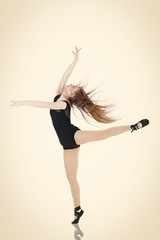 Young and beautiful dancer posing in studio.