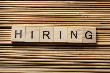 HIRING word written on wood block. Wooden Abc