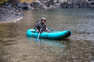 Autumn fishing after snowfall on the lake Kolsai, Kazakhstan
