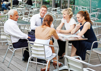 Business people in team working in coffee shop