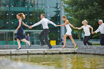 Business team running with holding hands