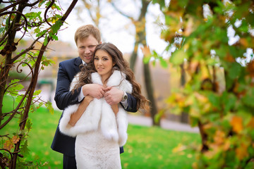 Happy young couple in love at the park in autumn.