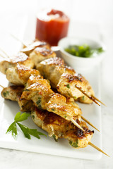 Chicken skewers with tomato sauce