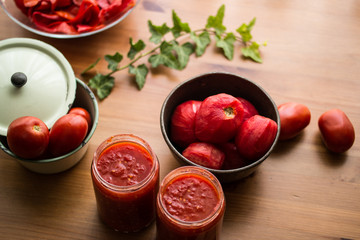 Tomato Paste on a wooden surface with concept backround.