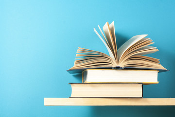 Open book, hardback books on wooden table. Education background. Back to school. Copy space for text.