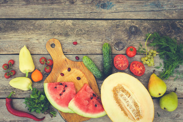Fruits, vegetables on wooden background. Toned image. 