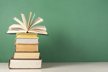 Open book, hardback books on wooden table. Education background. Back to school. Copy space for text.