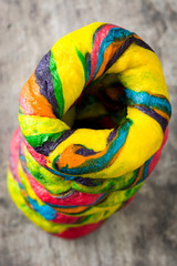 Colorful bagels on rustic wooden table background
