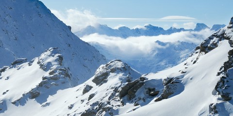 Winter mountains panoramic view with clouds in the valley. Corvatsch, Engadin, Switzerland. 