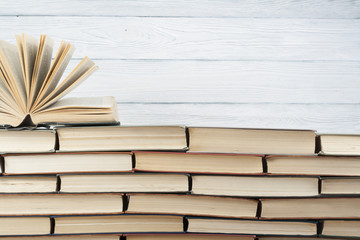 Open book, hardback books on wooden table. Education background. Back to school. Copy space for text.