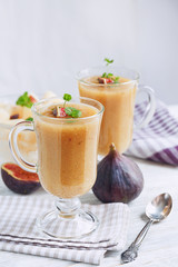 A delicious fresh melon and fig smoothie in a glass with a slice