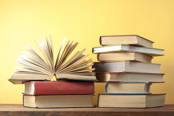 Open book, hardback books on wooden table. Education background. Back to school. Copy space for...