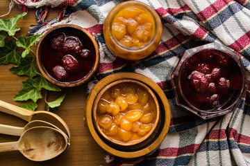 Strawberry and Yellow Cherry Jam with a Rustic Tablecloth.