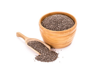 Wooden bowl with chia seeds and a spoon next to it on white background