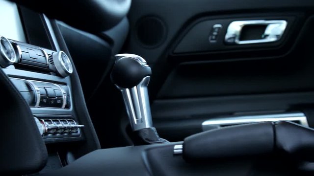 Panoramic and rail shooting of automatic gear box shift knob inside sport car