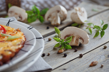 Omelet with onion, tomatoes and mushrooms