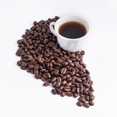 Cup of coffee arranged with fresh roasted coffee beans