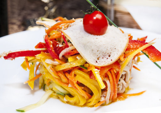spaghetti with cheese and egg on a white plate in a restaurant