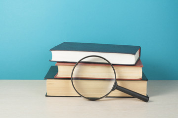 Open book, hardback books on wooden table. Education background. Back to school. Copy space for text.