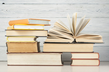 Open book, hardback books on wooden table. Education background. Back to school. Copy space for text.