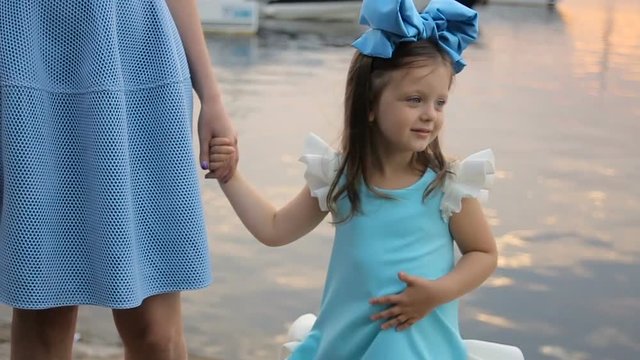portrait of a little girl three years with the blue bow on her head