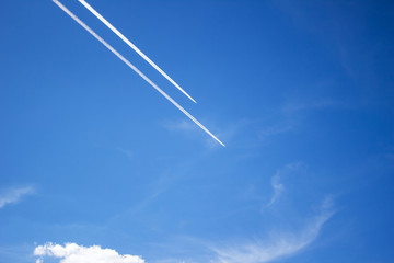 Two planes flying in parallel, leaving behind a white trail.
