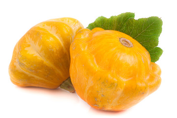 two yellow pattypan squash with leaf isolated on white background
