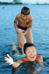 Fototapeta na wymiar mother with son bathing in the sea