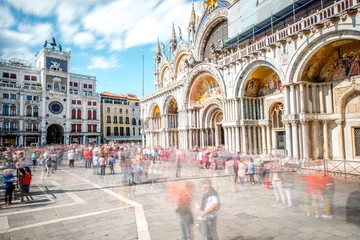 Tuinposter Saint Mark's square with basilica and clocktower in Venice. Long exposure image technic with motion blurred people © rh2010