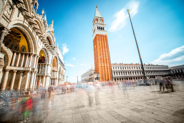 Saint Mark's square with campanille and basilica in Venice. Long exposure image technic with motion blurred people