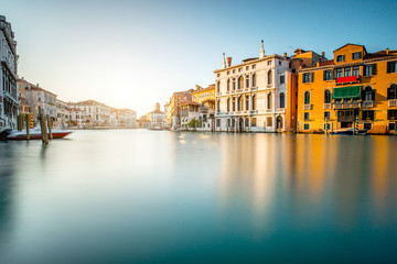 Venice cityscape view on Grand canal with colorful buildings and boats. Long exposure image technic with glossy water