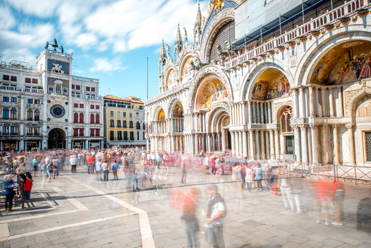 Saint Mark's square with basilica and clocktower in Venice. Long exposure image technic with motion blurred people