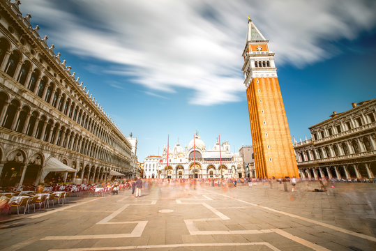 Saint Mark's square with campanille and basilica in Venice. Long exposure image technic with motion blurred people