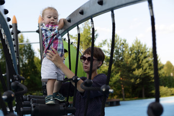 Obraz premium Mother with son at playground