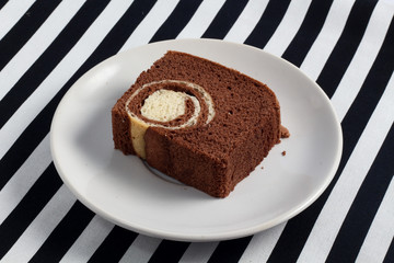 belgium chocolate cake loaf focus on slice on wood with sackclot