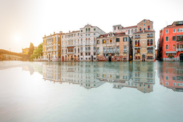 Venice cityscape view on Grand canal with beautiful buildings on the sunset. Long exposure image technic with reflection on the water
