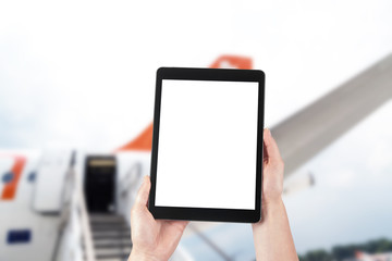 tablet with blank screen for copy and airplane in background