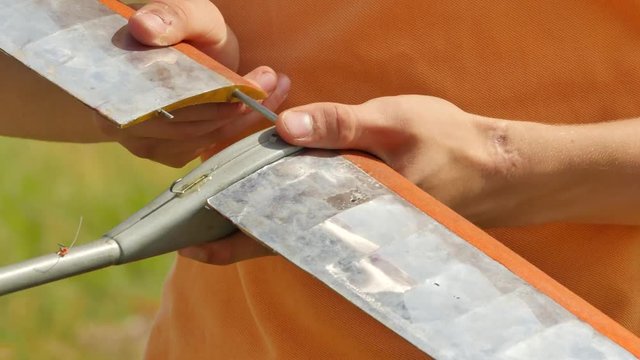 Boy's Hands Are Assembling a Wing of Aircraft Model People at Aircraft Models Competition Outdoors Konotop Ukraine Preparation For Airplane Launch Sunny