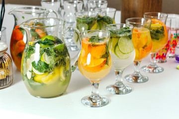Cocktail with orange and mint. A few glasses.