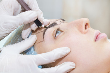Fototapeta na wymiar Mikrobleyding eyebrows workflow in a beauty salon