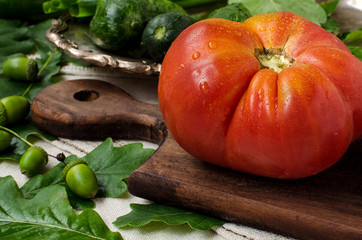 A large tomato with drops of dew.