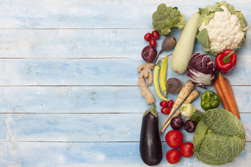  Vegetables on a blue wooden board, top view