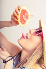 Summer girl holding grapefruit drink
